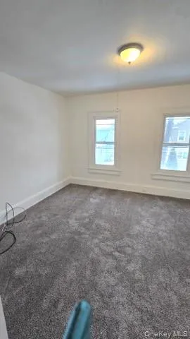an empty room with a empty space and windows