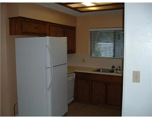 a kitchen with a refrigerator and a cabinets