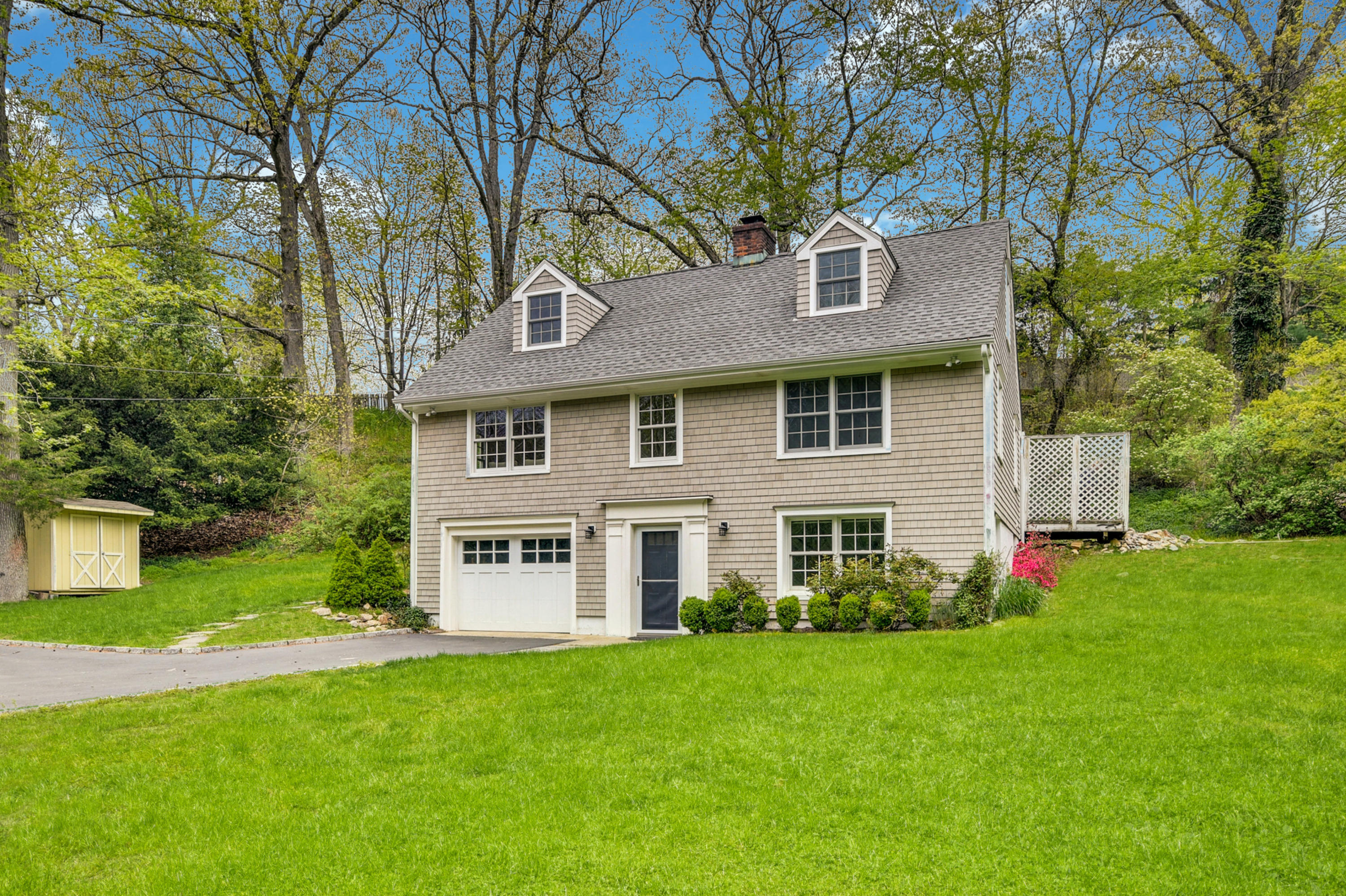 212 Tokeneke Road Darien, CT 06820 - Photo 1 of 23 a front view of a house with a garden