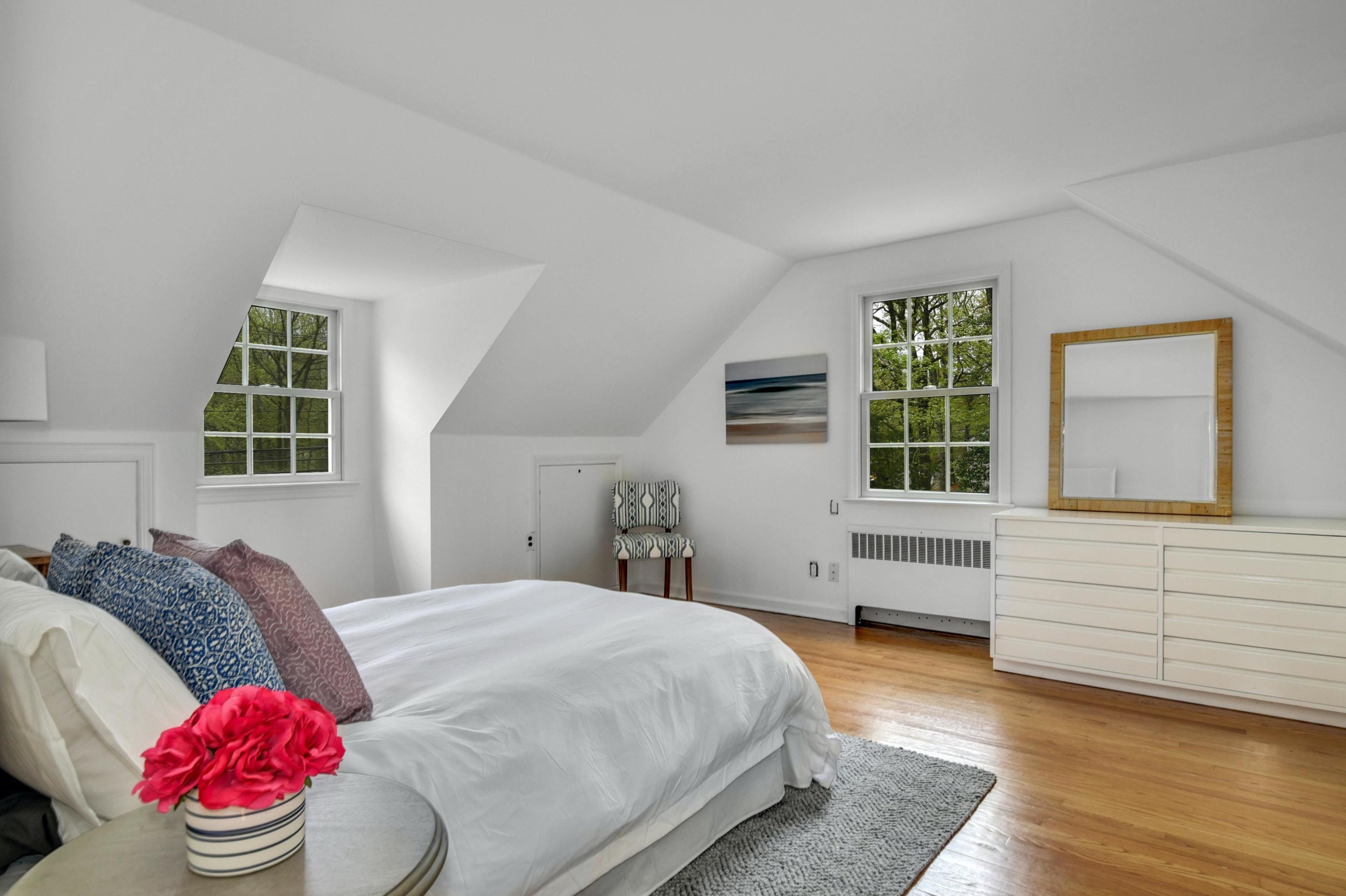 212 Tokeneke Road Darien, CT 06820 - Photo 11 of 23 a spacious bedroom with a bed and a window