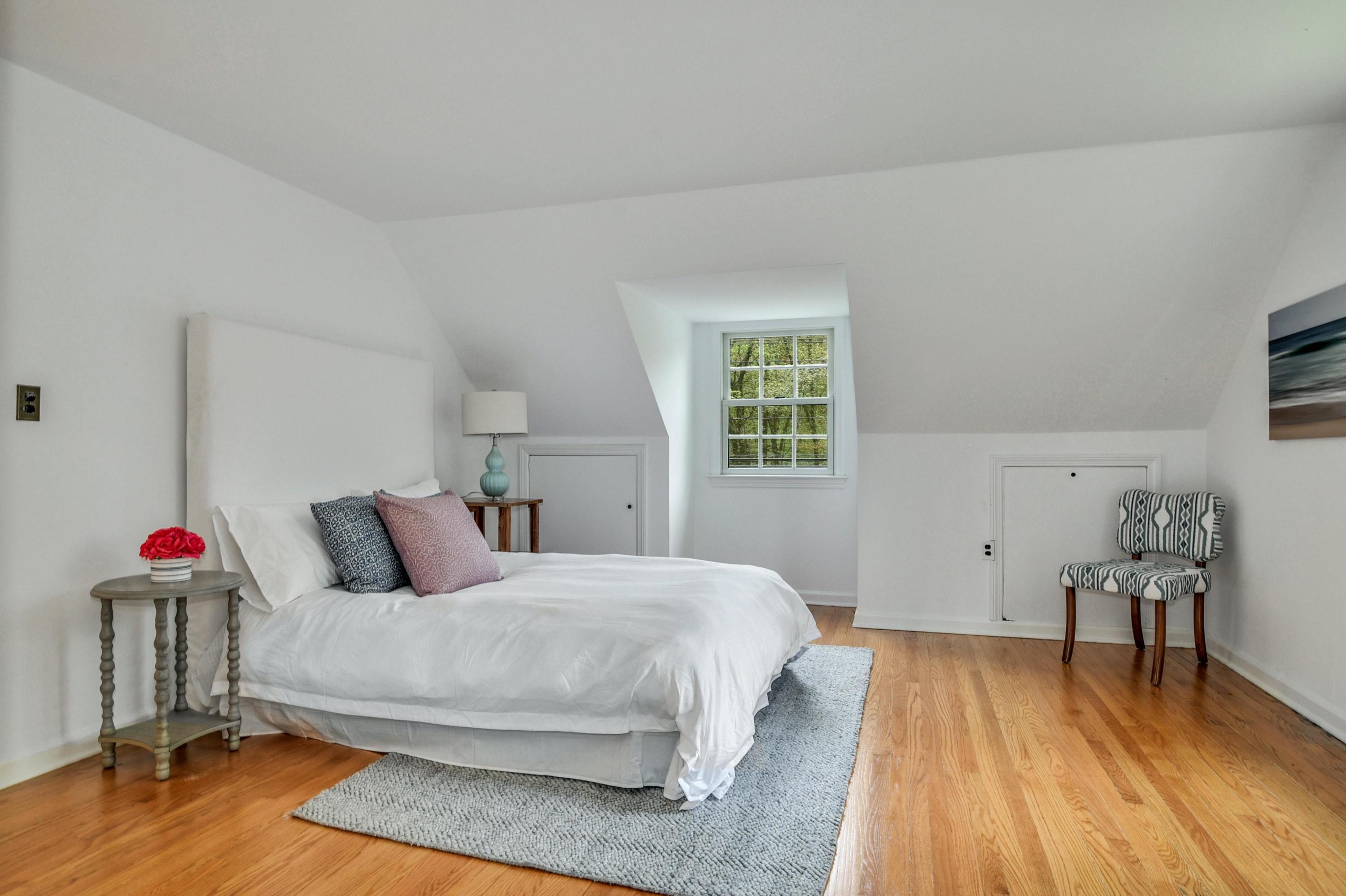 212 Tokeneke Road Darien, CT 06820 - Photo 12 of 23 a bedroom with a bed and wooden floor