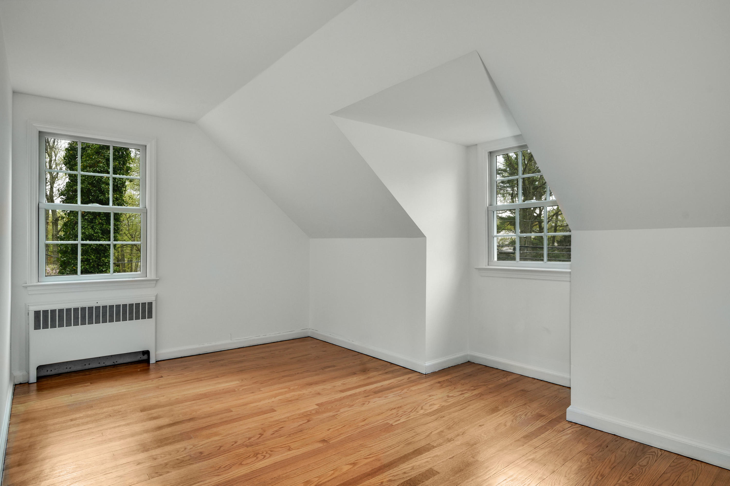 212 Tokeneke Road Darien, CT 06820 - Photo 14 of 23 an empty room with wooden floor and windows