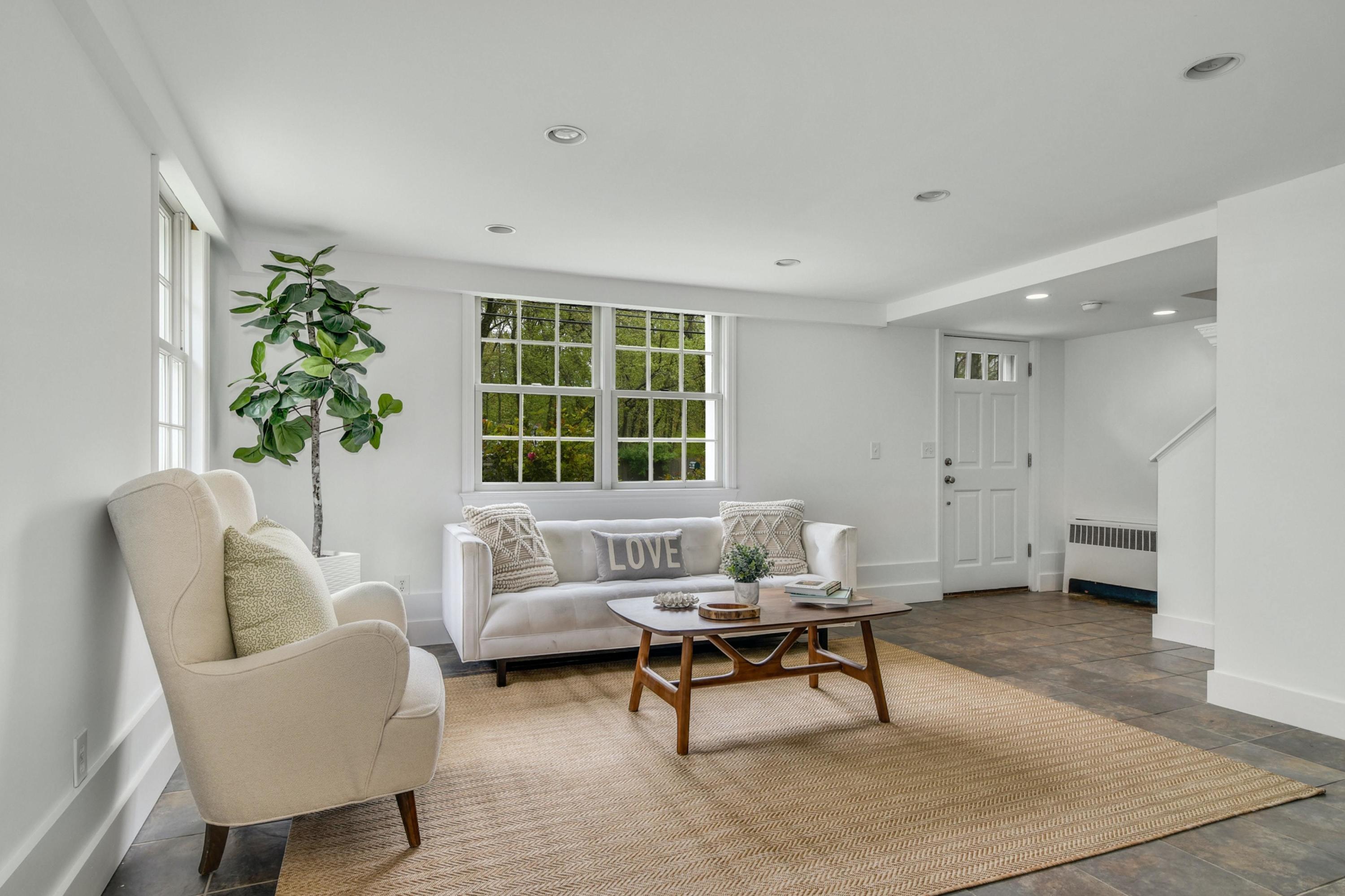 212 Tokeneke Road Darien, CT 06820 - Photo 15 of 23 a living room with furniture and a potted plant