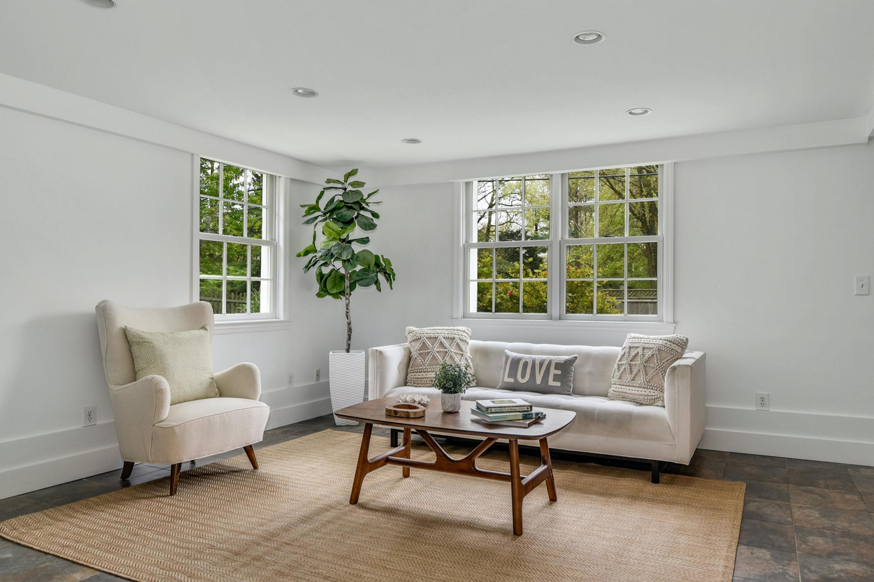212 Tokeneke Road Darien, CT 06820 - Photo 16 of 23 a living room with furniture and a large window