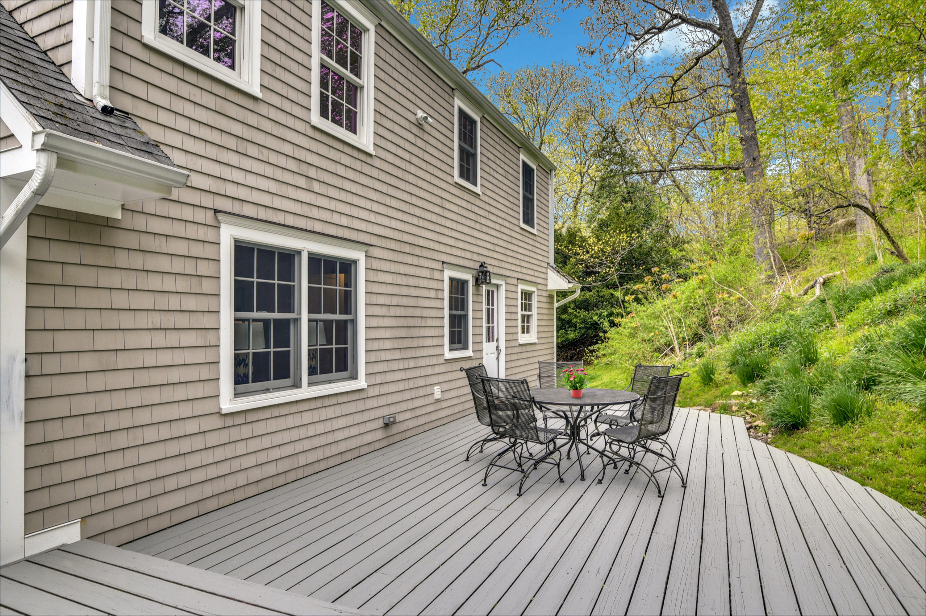 212 Tokeneke Road Darien, CT 06820 - Photo 19 of 23 a view of a house with chairs and table on the wooden deck