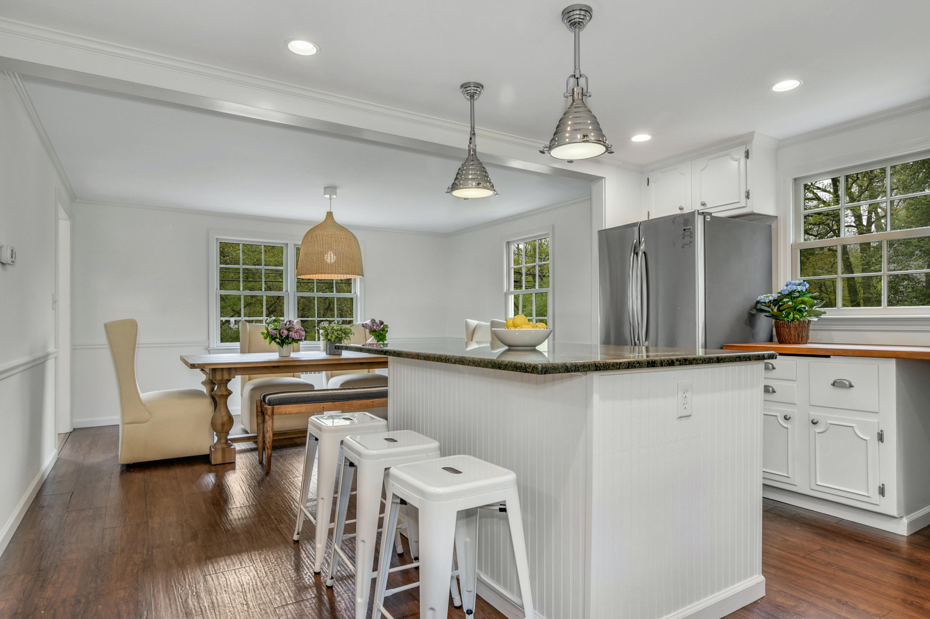 212 Tokeneke Road Darien, CT 06820 - Photo 8 of 23 a kitchen with stainless steel appliances a dining table chairs and wooden floor