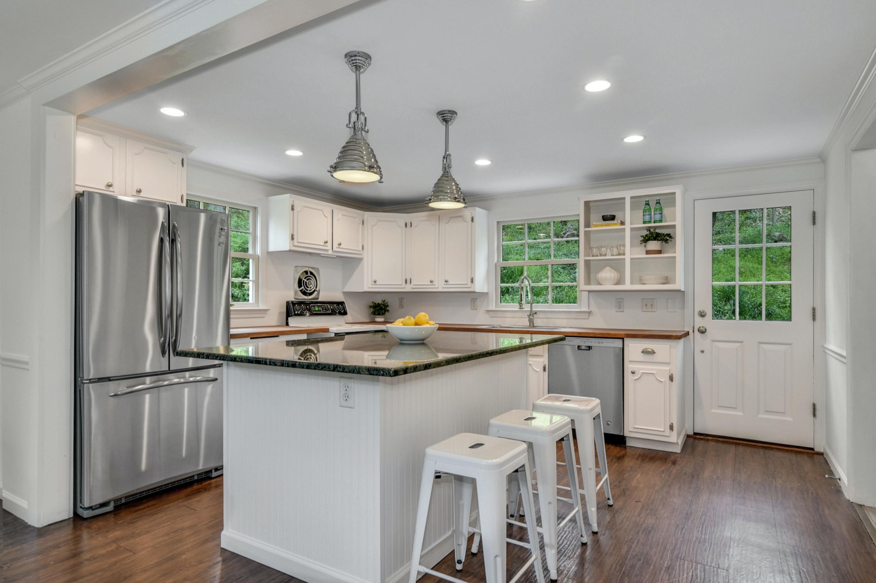 212 Tokeneke Road Darien, CT 06820 - Photo 9 of 23 a kitchen with stainless steel appliances granite countertop a sink a stove a refrigerator and island with wooden floor