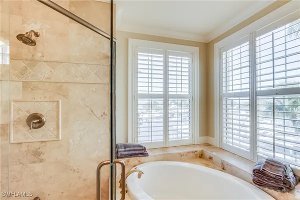 a bathroom with a tub sink and window