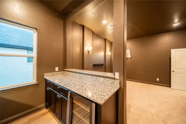 a view of a big room with wooden floor and windows