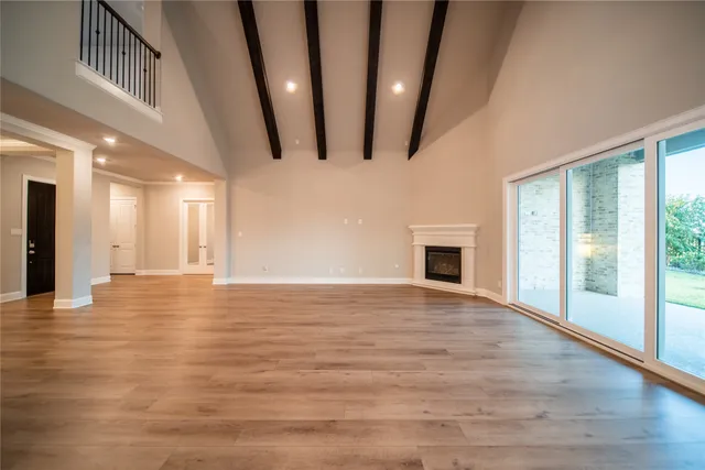 a large kitchen with stainless steel appliances lots of counter space and wooden floor