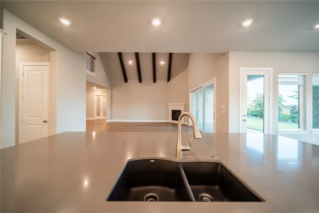 a kitchen with a sink a stove and a refrigerator
