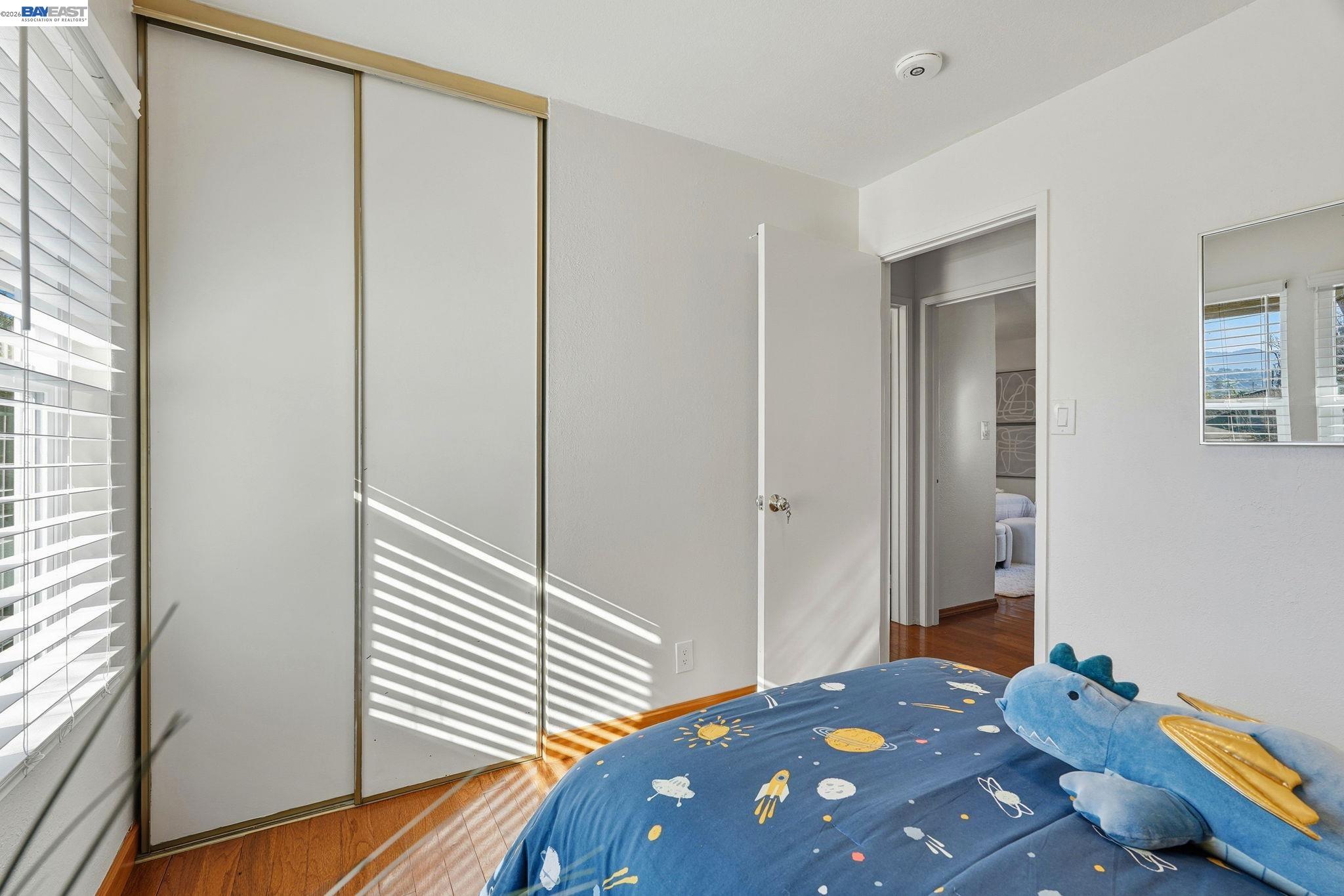 21091 Red Fir Court Cupertino, CA 95014 - Photo 20 of 39 a bedroom with a bed and wooden floor