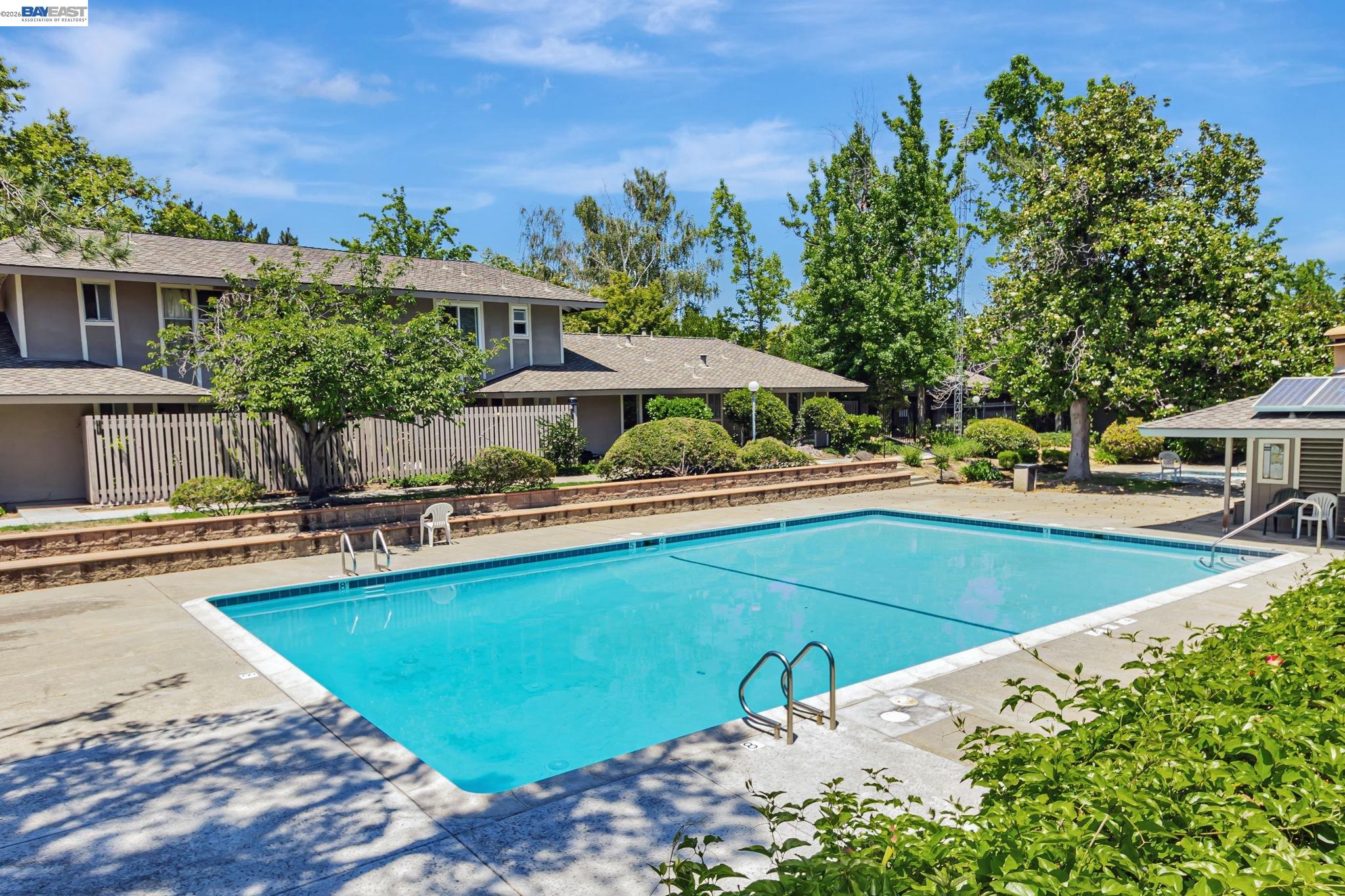 21091 Red Fir Court Cupertino, CA 95014 - Photo 36 of 39 a view of a swimming pool with lawn chairs under an umbrella