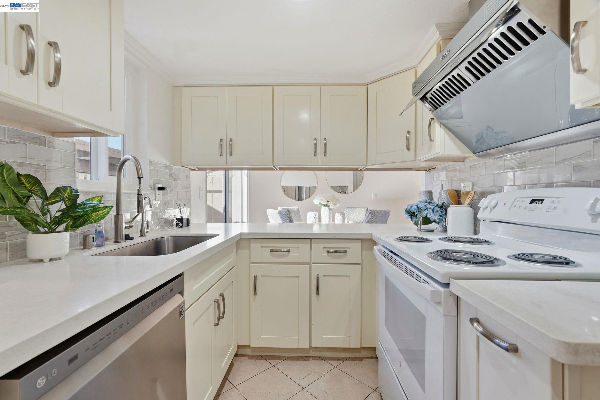 21091 Red Fir Court Cupertino, CA 95014 - Photo 9 of 39 a kitchen with cabinets appliances a sink and a counter top