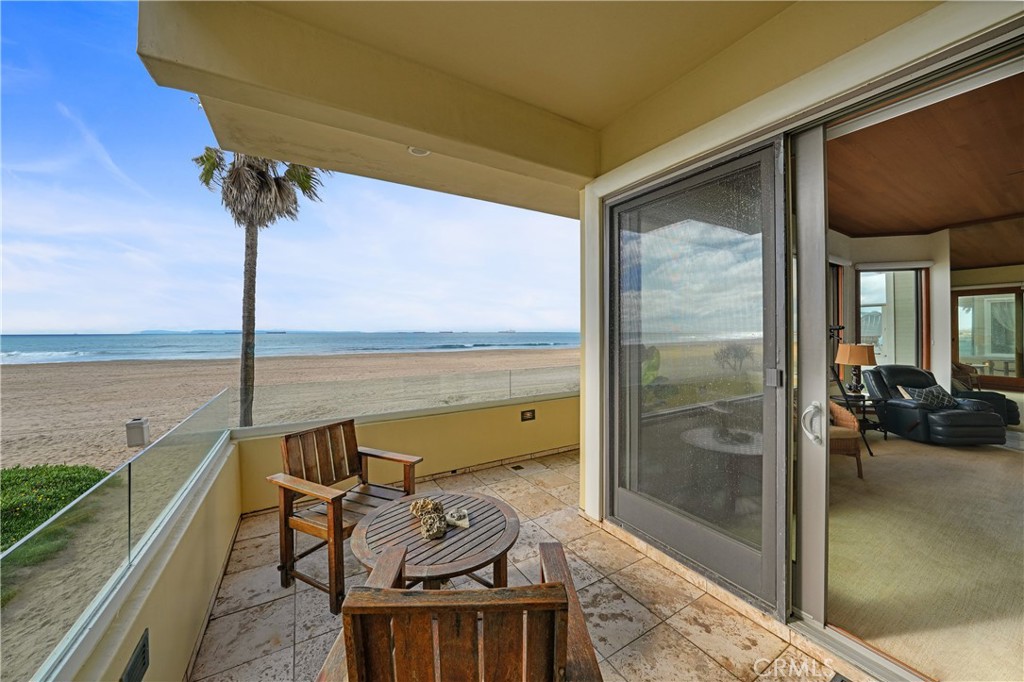 72-B Surfside Avenue Surfside, CA 90743 - Photo 14 of 56 a view of a balcony with chair and glass door