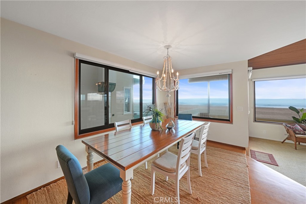 72-B Surfside Avenue Surfside, CA 90743 - Photo 22 of 56 a dining room with furniture and wooden floor