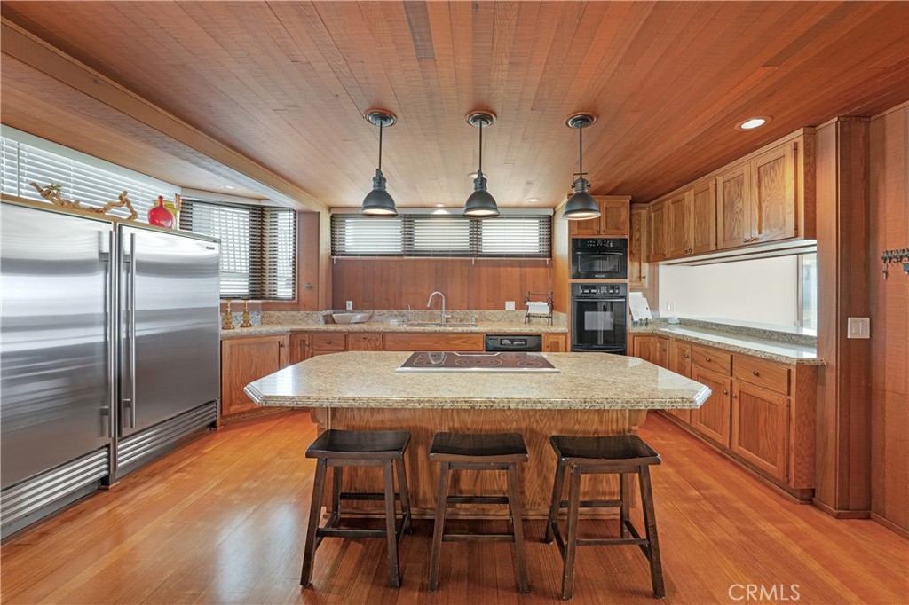 72-B Surfside Avenue Surfside, CA 90743 - Photo 28 of 56 a kitchen with kitchen island a counter top space cabinets stainless steel appliances and wooden floor