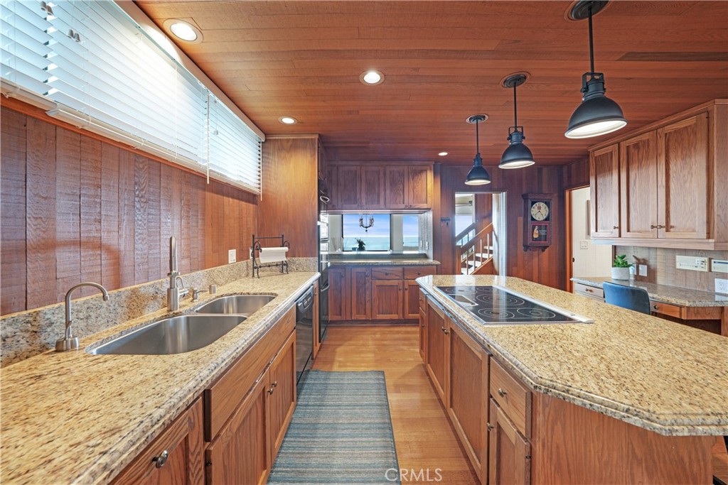 72-B Surfside Avenue Surfside, CA 90743 - Photo 30 of 56 a kitchen with granite countertop a sink and a stove