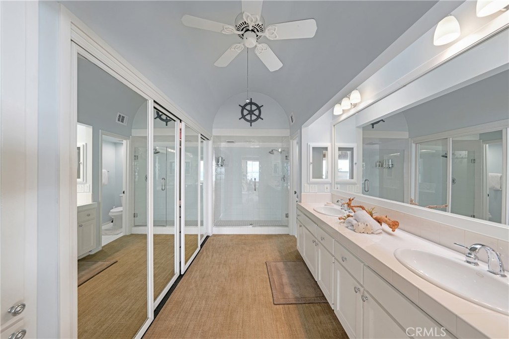 72-B Surfside Avenue Surfside, CA 90743 - Photo 40 of 56 a spacious bathroom with a double vanity sink a large mirror and shower