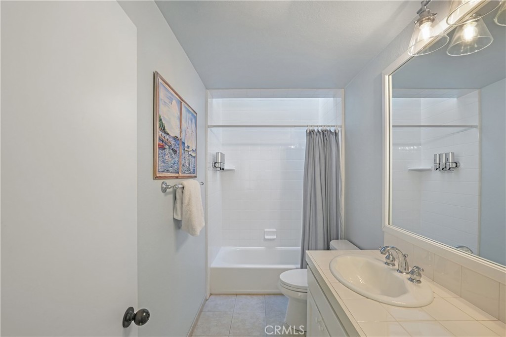 72-B Surfside Avenue Surfside, CA 90743 - Photo 46 of 56 a bathroom with a granite countertop sink a toilet and shower