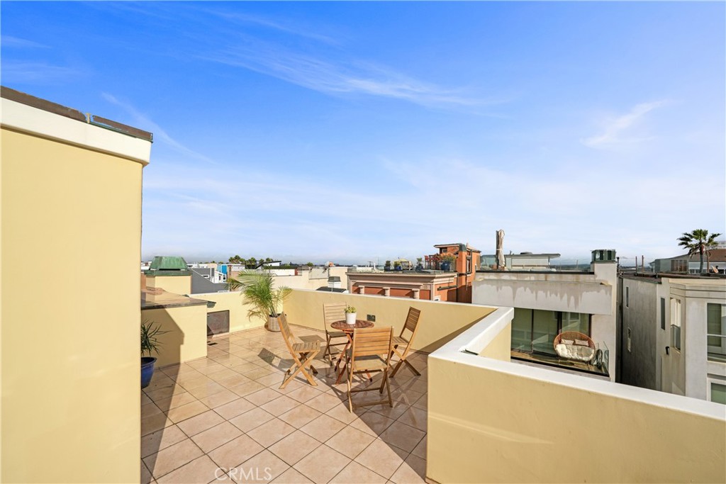 72-B Surfside Avenue Surfside, CA 90743 - Photo 51 of 56 a view of a terrace with furniture and a floor to ceiling window