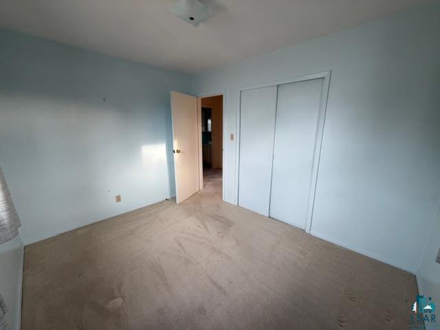 50 Beech Circle Babbitt, MN 55706 - Photo 13 of 24 Open interior space featuring light blue walls and neutral carpet flooring
