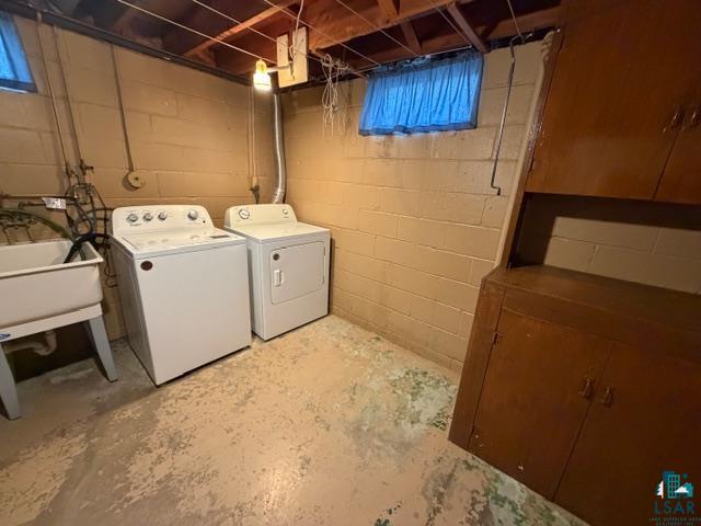 50 Beech Circle Babbitt, MN 55706 - Photo 14 of 24 Laundry area featuring a utility sink, built-in cabinetry, and exposed ceiling joists