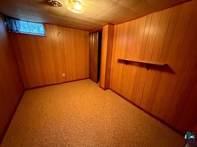 50 Beech Circle Babbitt, MN 55706 - Photo 15 of 24 Room featuring wood paneling, patterned carpet flooring, and a low window