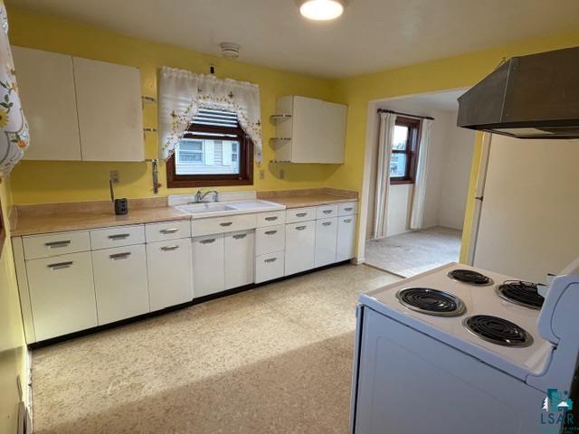 50 Beech Circle Babbitt, MN 55706 - Photo 2 of 24 Kitchen featuring white cabinetry, light-toned countertops, an integrated sink, and an electric range