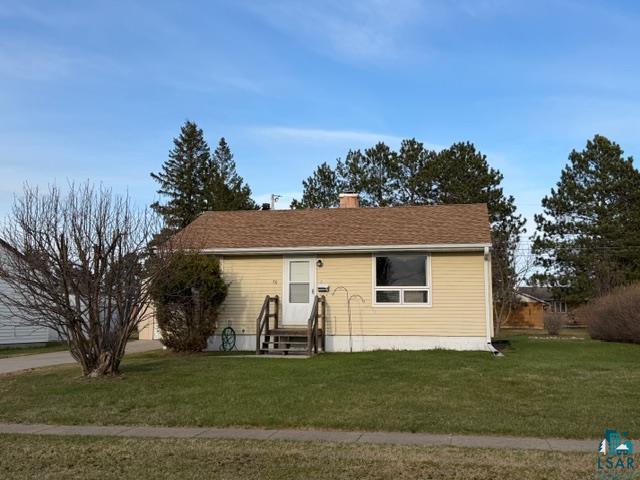 50 Beech Circle Babbitt, MN 55706 - Photo 24 of 24 Yellow siding exterior with a brown shingle roof, featuring a front entry with wooden steps and railing