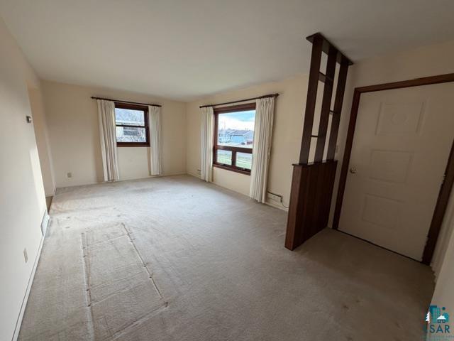 50 Beech Circle Babbitt, MN 55706 - Photo 8 of 24 Bright living space featuring light-colored carpet flooring and neutral wall tones