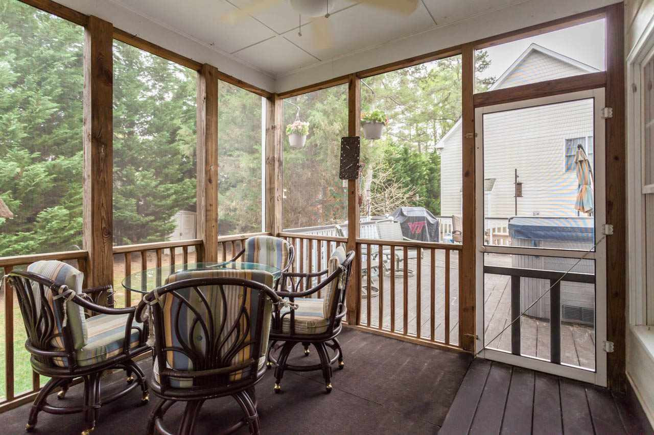 8412 Aptos Court Raleigh, NC 27613 - Photo 23 of 25 Screen porch is located off the of the family room and leads to the extensive deck. Screen porch