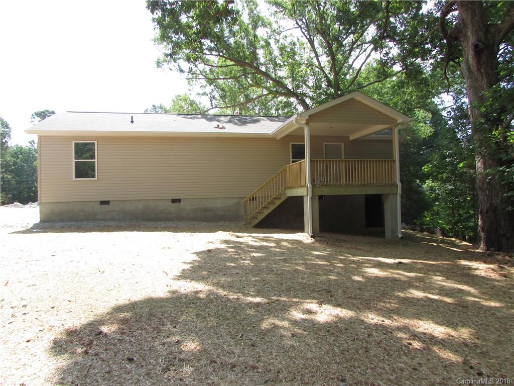 1562 Old Pinckney Road York, SC 29745 - Photo 6 of 9 a backyard of a house with large trees and garage