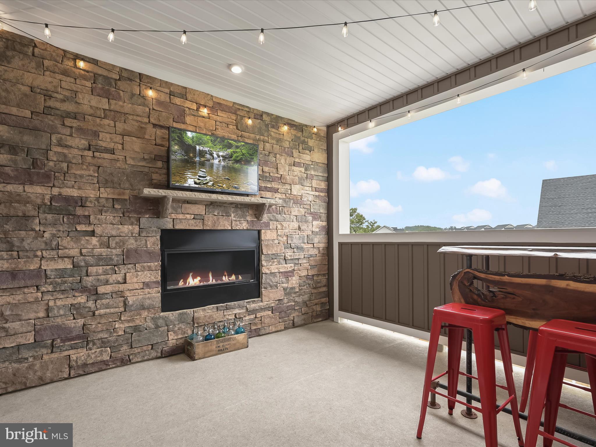 7330 Isabella Road Laurel, MD 20723 - Photo 11 of 47 a living room with furniture a fireplace and a floor to ceiling window