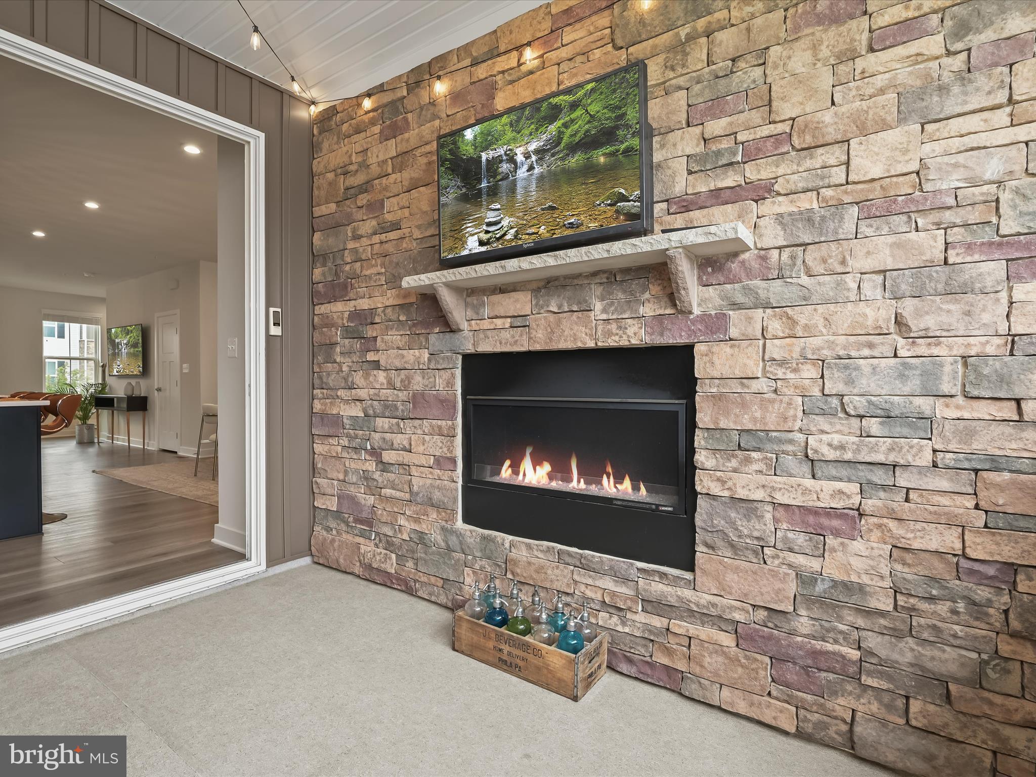 7330 Isabella Road Laurel, MD 20723 - Photo 12 of 47 a fireplace with a clock on wooden wall