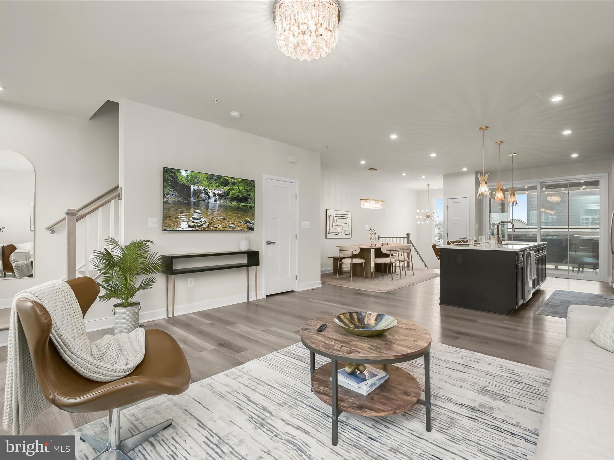 7330 Isabella Road Laurel, MD 20723 - Photo 15 of 47 a living room with furniture a rug kitchen view and a chandelier