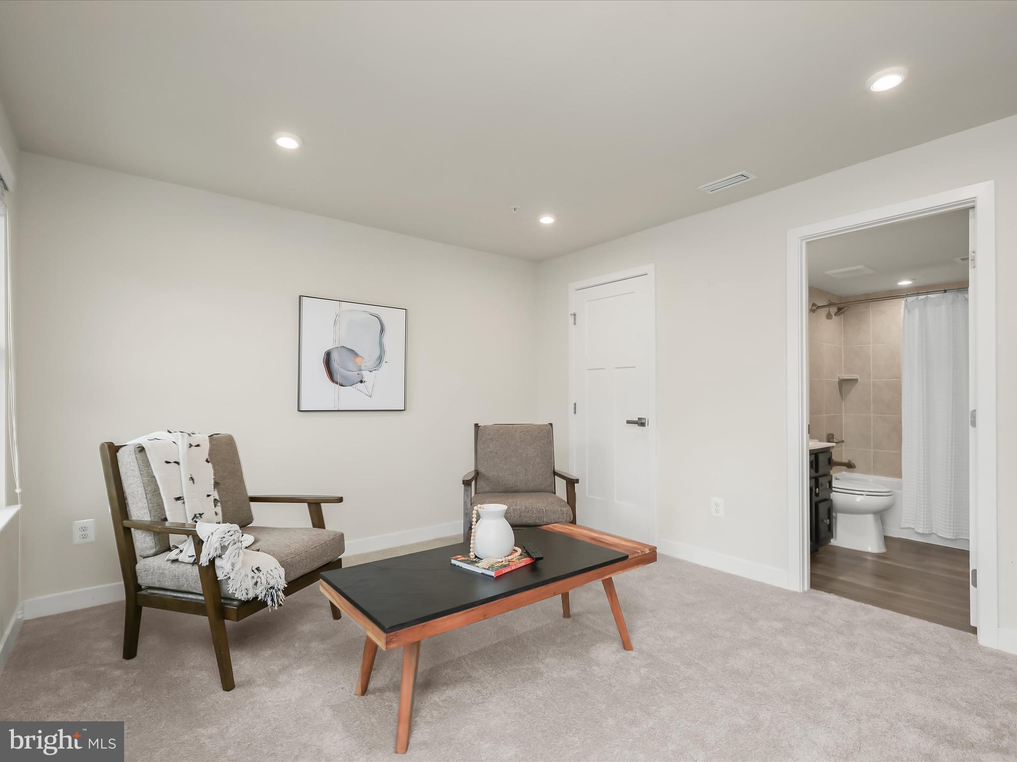7330 Isabella Road Laurel, MD 20723 - Photo 34 of 47 a living room with furniture a rug and a table