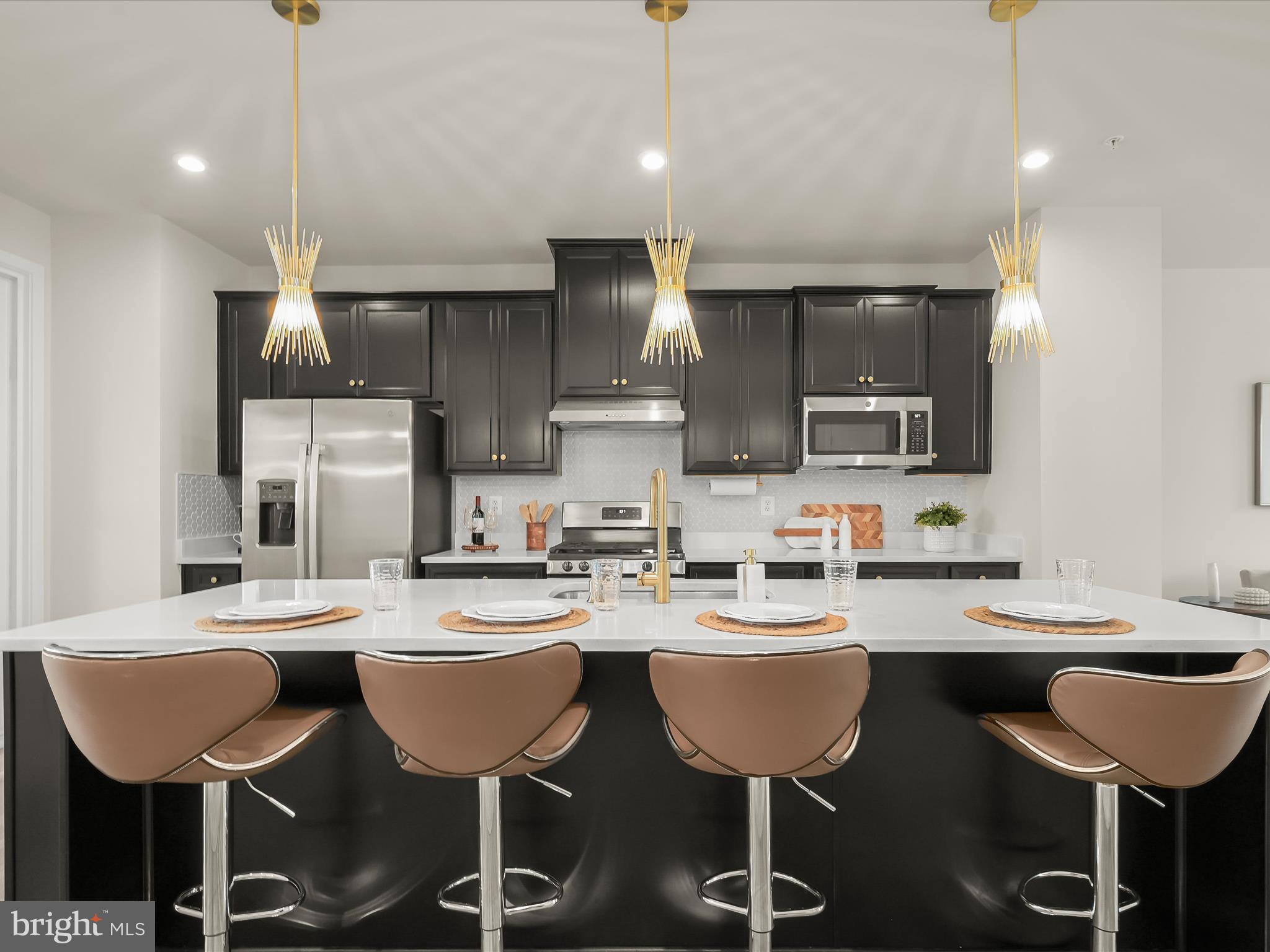 7330 Isabella Road Laurel, MD 20723 - Photo 5 of 47 a kitchen with a dining table chairs sink and cabinets