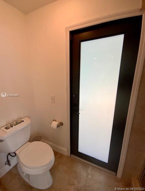 19715 Sedgefield Terrace Boca Raton, FL 33498 - Photo 22 of 43 master bath toilet closet with pool access