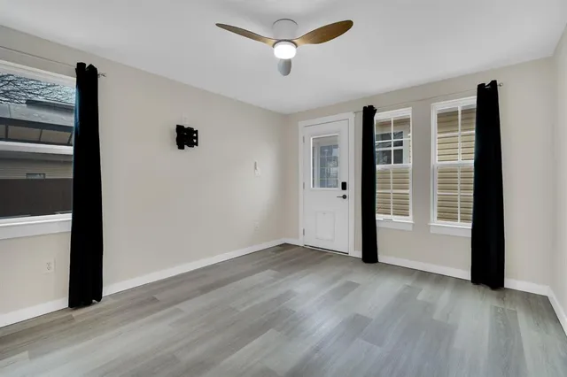 wooden floor in an empty room with a window