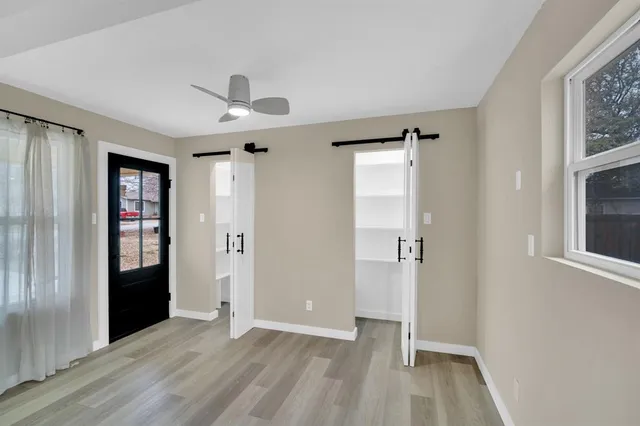 wooden floor in an empty room with a window