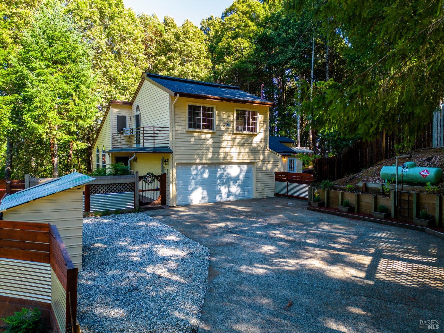 a view of a house with backyard and sitting area