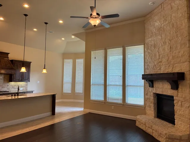 a view of a livingroom with a fireplace and window