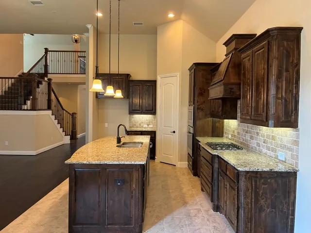 a kitchen with counter top space and sink