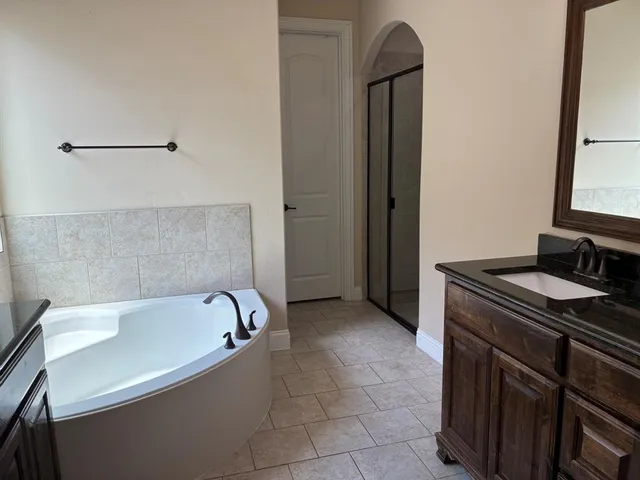 a bathroom with a bathtub and a window