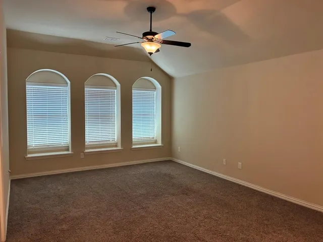 a view of room with window and ceiling fan
