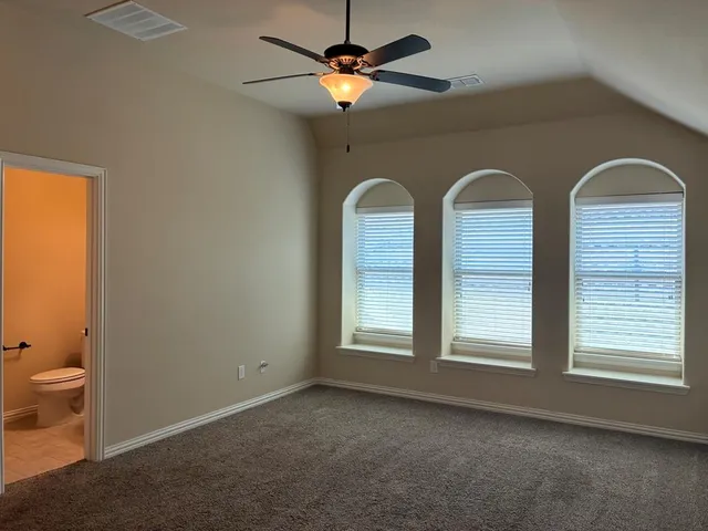a view of a livingroom with a ceiling fan and window