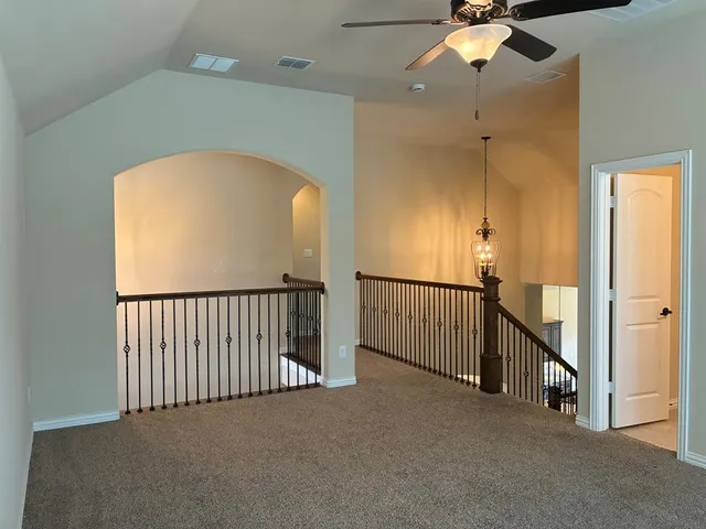 a view of a hallway with entryway and chandelier