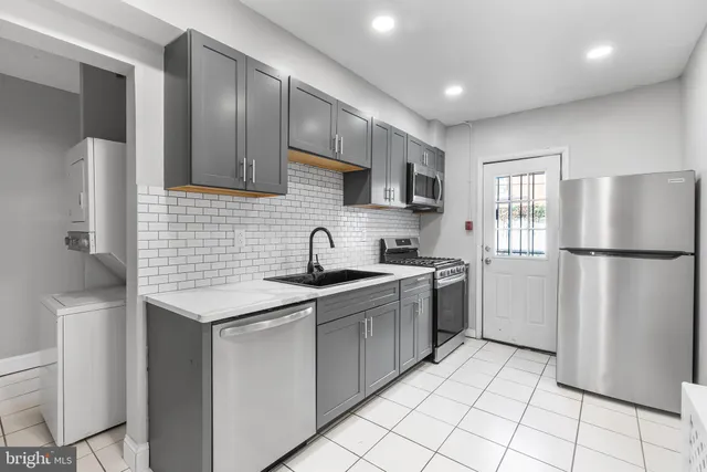 a kitchen with stainless steel appliances granite countertop a refrigerator sink and cabinets