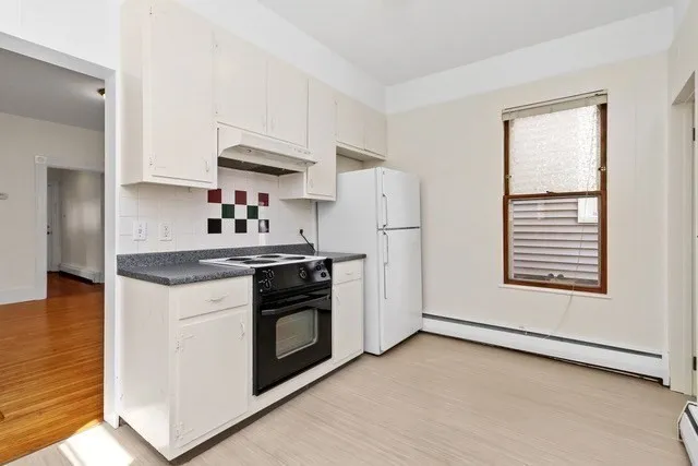 a kitchen with stainless steel appliances granite countertop a stove a refrigerator and a microwave